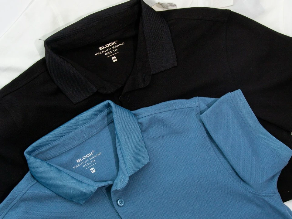 a group of three polo shirts sitting on top of each other